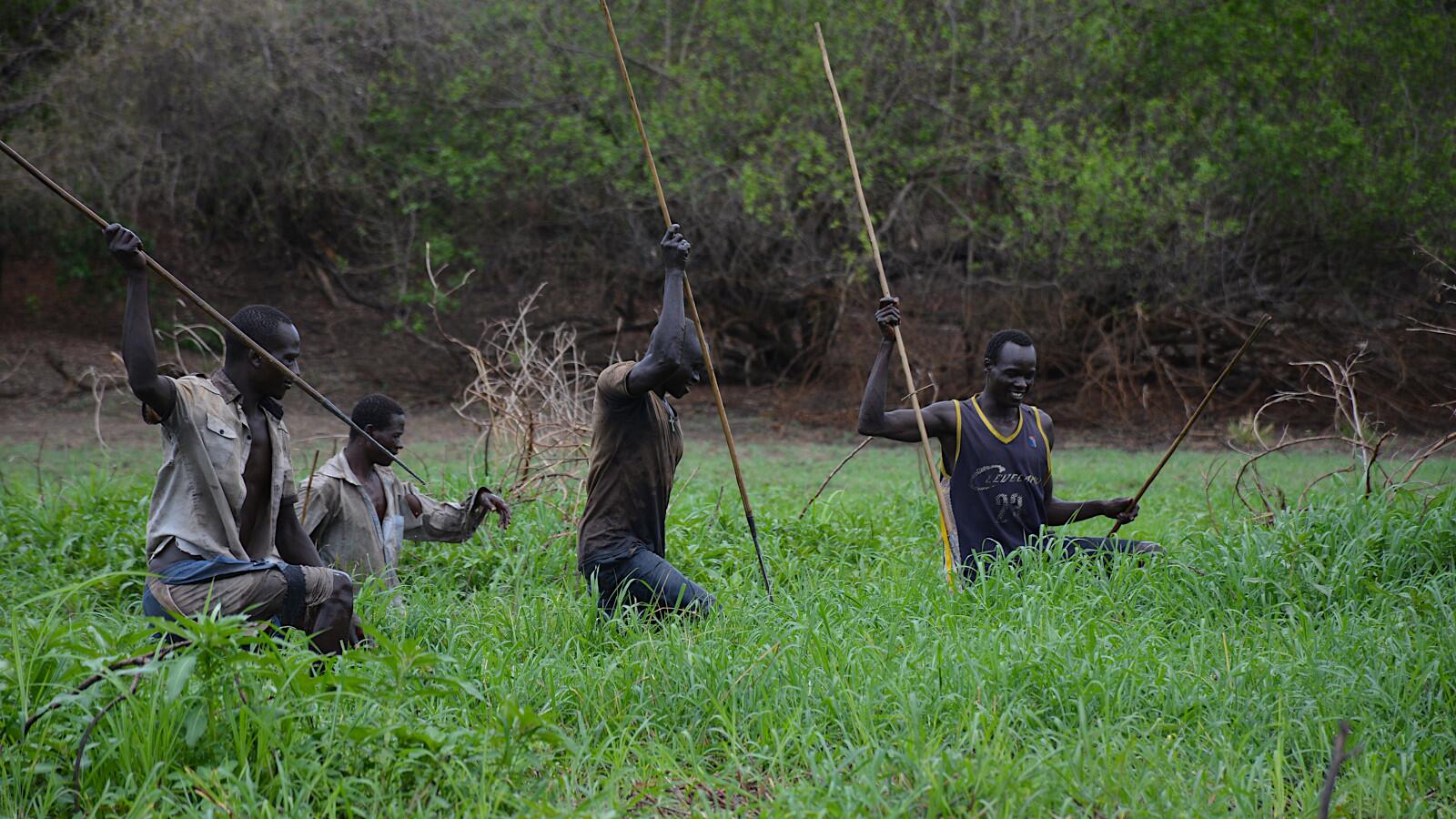 Opo men fishing with spears.